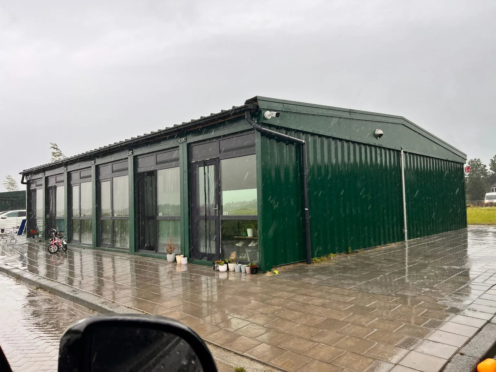 40FT container conversion — interior living zone with sofa and side tables.