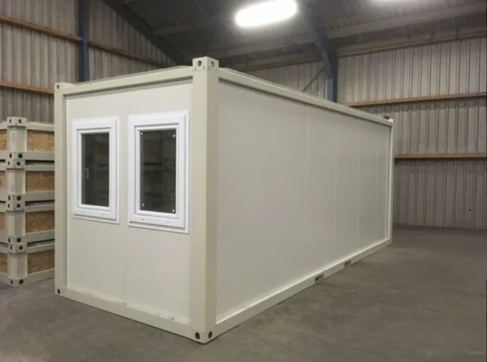 P2460 L flatpack container — wider site context with paved approach.